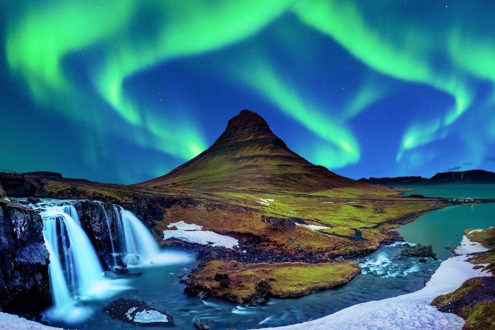 Aurora borealis at Kirkjufell in Iceland. Kirkjufell mountains in winter